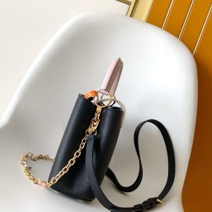 Alternative view of p1180M11343 Pure White with Pink M25386 Black with White M23952 White with Blue M24471 Green M22514 White with Yellow M22375 Crocus M20845 Pure White M20844 Peach Pink M22512 Black with Pink Premium Genuine Leather Dynamic Encryption Chip This Capucines Mini Handbag features a Taurillon leather body with an elegant Lovelock chain, where woven links frame hand-painted enamel Monogram elements and an LV monogram padlock. A leather LV logo adds a striking accent.26.5 x 17.5 x 9.0 cm (L x H x W) 21.0 x 14.0 x 8.0 cm (L x H x W) 16.3 x 11.0 x 6.5 cm (L x H x W) • Taurillon leather • Taurillon leather trim •Cowhide leather lining•Metal hardware•Glazed effect•Flap can be positioned inside or outside•Interior compartment with patch pocket•Metal studs•Shoulder strap: Detachable, adjustable•Strap length: 55.0 cm•Adjustable to: 59.0 cm•Chain: Detachable•Chain length: 31.0 cm • Handle: Single handle